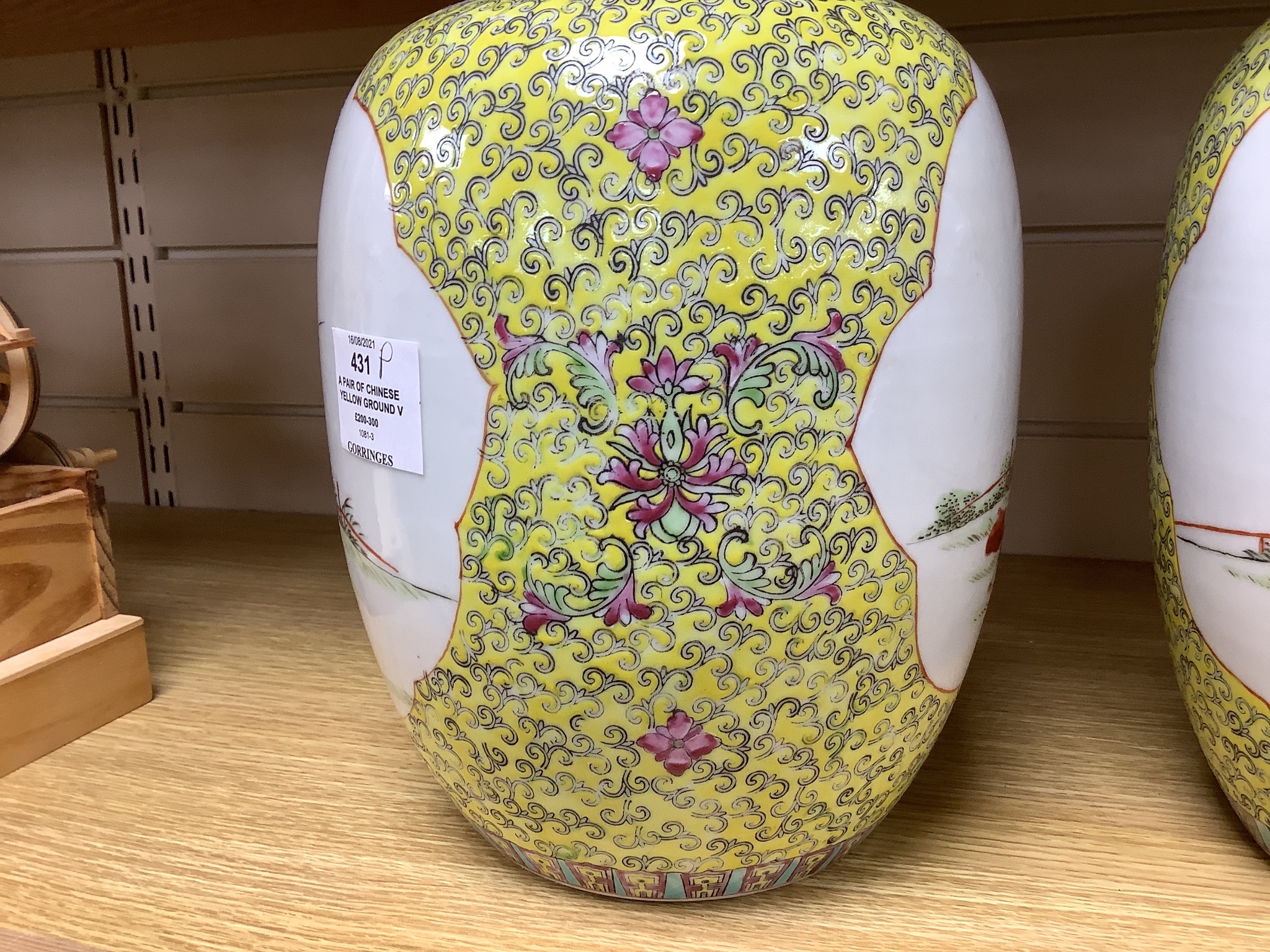 A pair of Chinese yellow ground vases and covers, height 30cm